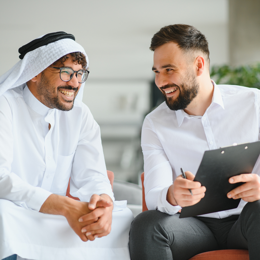International Operations Manager Meeting Saudi Business Partner in Traditional Kandura